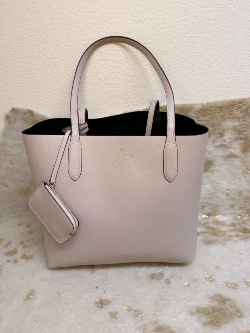 Stylish Kate Spade reversible tote in classic black with blush pink interior